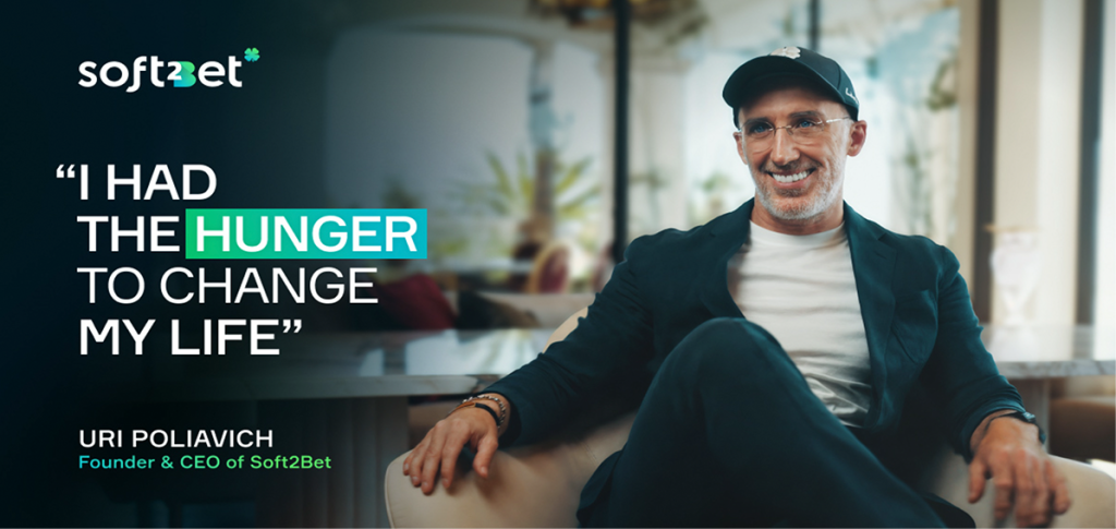 Uri Poliavich, Founder and CEO of Soft2Bet, smiling while seated in a modern office, with quote overlay: "I had the hunger to change my life’’